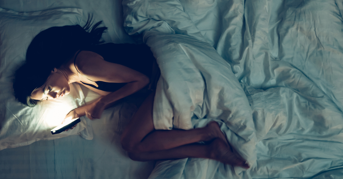 Girl Using Smartphone on Bed Before Sleeping. Mobile Addict Concept. Disappointed Sad Woman Holding Mobile Phone. Sleepy Exhausted Woman. Insomnia, Nomophobia, Sleep Disorder Concept.; Blog: can lack of sleep affect your fertility