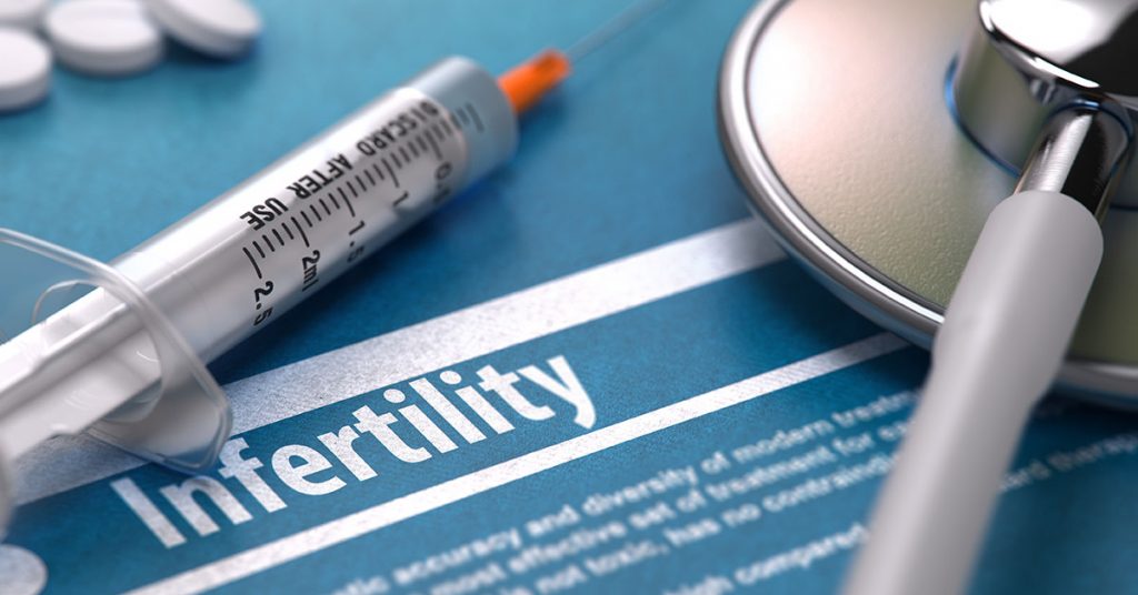 Infertility - Medical Concept on Blue Background with Blurred Text and Composition of Pills, Syringe and Stethoscope; blog: Translating Common Infertility Terms & Acronyms