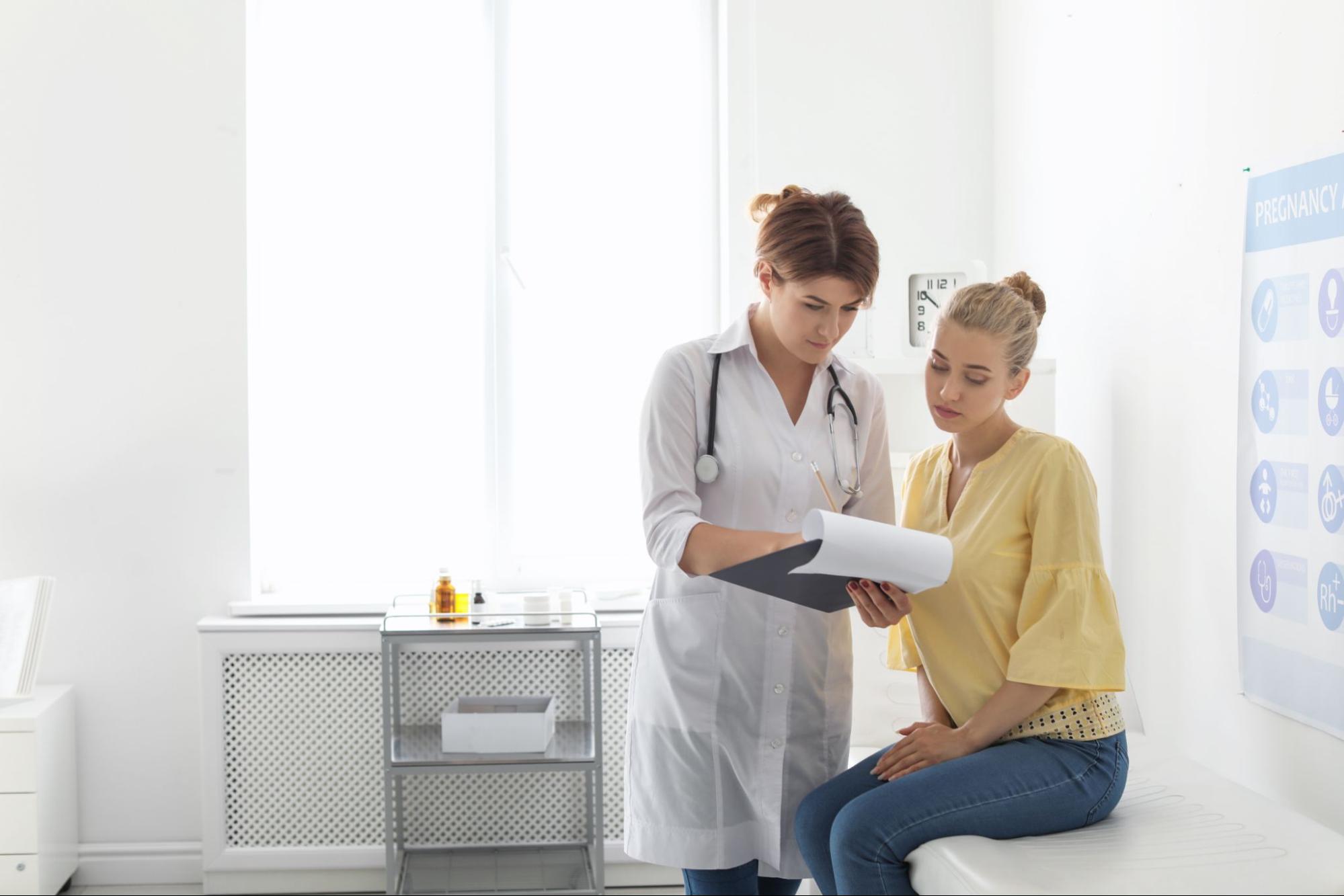 a female doctor reviewing a chart with a female patient