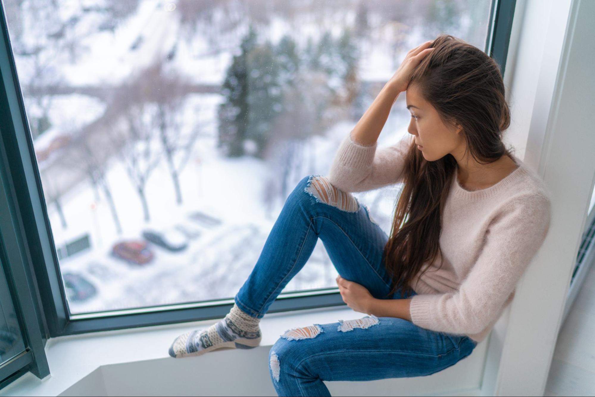 A woman feeling sad in winter to represent how to beat the winter blues